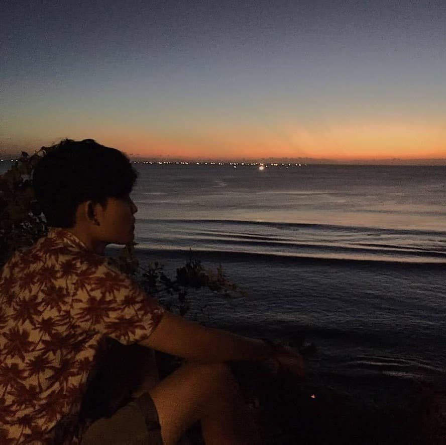 Gung Andre — Fullstack Developer based in Bali, sitting by the sunset